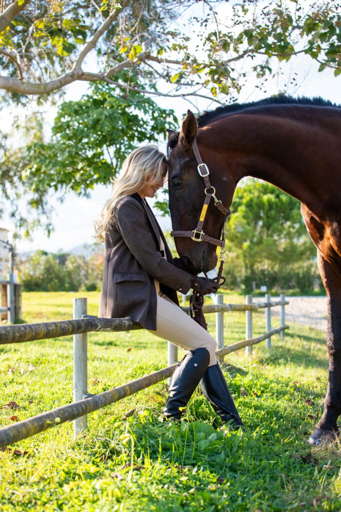 Girl on fence with horse